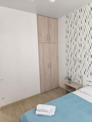 a white room with a bed and a cabinet at Apartment Gagarinsky in Arcadia in Odesa