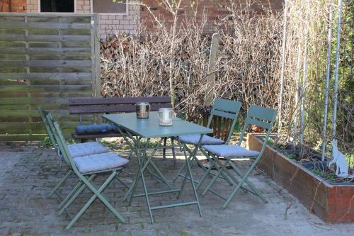 a blue table and chairs sitting next to a bench at Ferienwohnung Emma Fliessau Zernien in Zernien