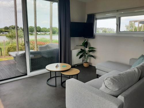a living room with a couch and a table at Camping de Vogel in Hengstdijk