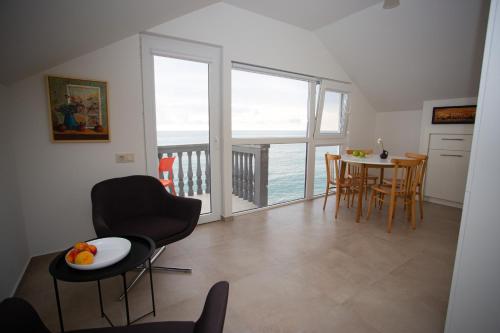 a kitchen and dining room with a view of the ocean at Sea View Boutique Apartments in Chakvi