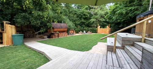 a garden with a wooden deck and a lawn at Weddeloase in Medebach