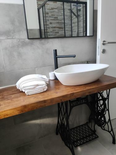 a bathroom with a large white sink on a wooden table at Casetta del Sole in Vallecrosia
