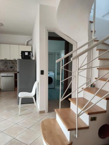 a staircase in a kitchen with a table and a chair at Casetta del Sole in Vallecrosia