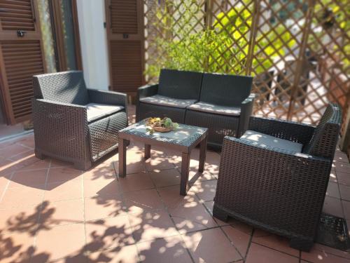 a group of chairs and a table on a patio at Casetta del Sole in Vallecrosia