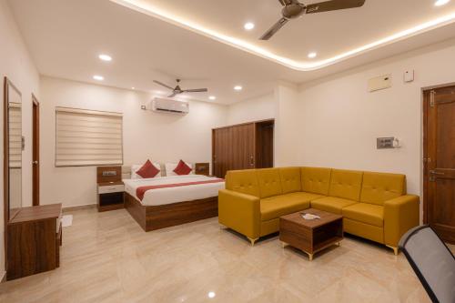 a living room with a couch and a bed at Elysium Studio Suites Madhapur in Hyderabad