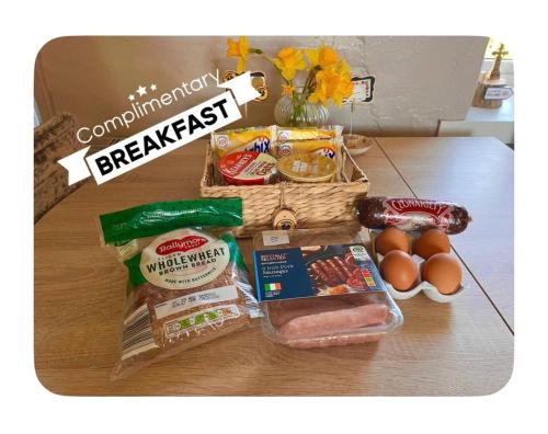 a table with a basket filled with food and eggs at Daffodil Lodge in Sligo