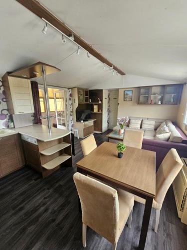 a kitchen and living room with a table and a couch at Entre Terre et Mer in Le Tréport