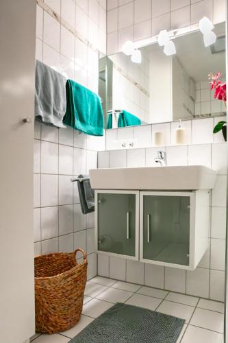 a bathroom with a sink and a mirror at Ferienwohnung Creutzig in Stockach