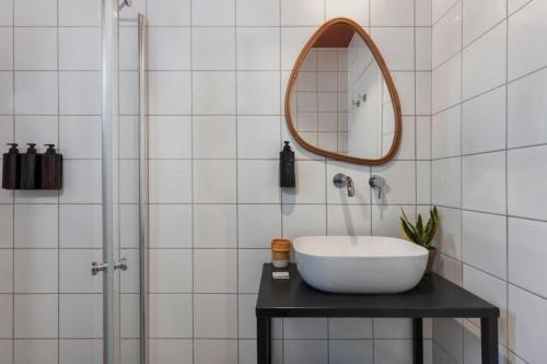 a bathroom with a sink and a mirror at Solaya Kineret in Migdal
