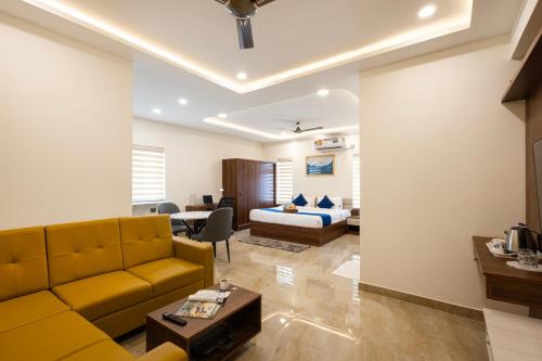 a living room with a couch and a bed at Elysium Studio Suites Madhapur in Hyderabad