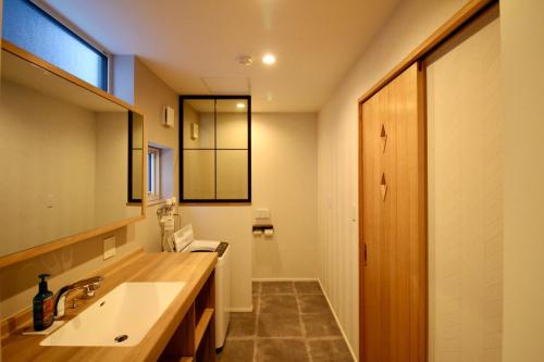 a bathroom with a sink and a mirror at Yotei View Tiny House in Kutchan