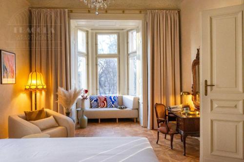 a bedroom with a living room with a couch and a window at Fragola Apartments Old Town in Kraków