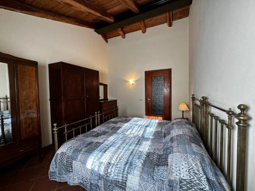 a bedroom with a bed with a blanket on it at Dormo in mulino in Bagnasco