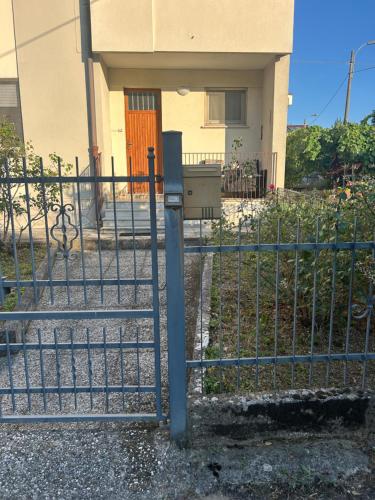 a fence with a mail box in front of a house at Casa Elena in Sistiana
