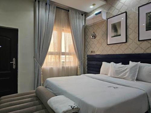 a bedroom with a large bed and a window at Phiona luxury apartment in Lekki
