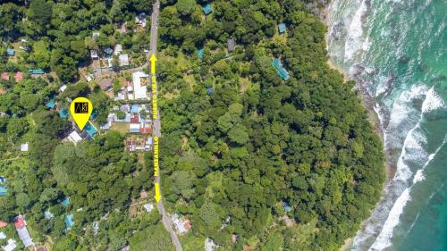 an aerial view of a road on a mountain next to the ocean at Aloki Wim 4 A pasos de la Playa in Punta Uva