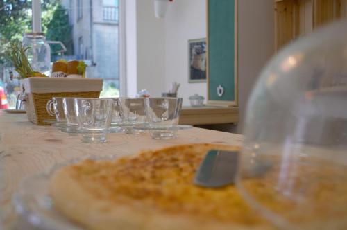 a table with glasses and a plate of food at The Rolé House in Gurjaani
