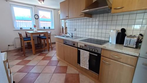 a kitchen with a sink and a stove top oven at Ferienwohnung Hermann Fliessau Zernien in Zernien