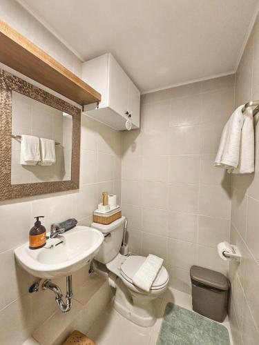 a bathroom with a toilet and a sink at Vito Condotel in Piapi