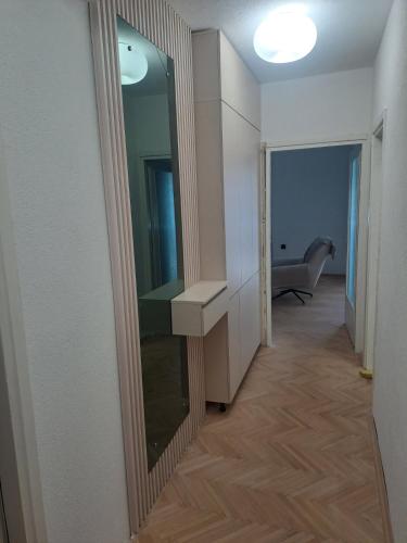 a bathroom with a mirror and a sink in a room at Angela Modern Apartment in Bitola