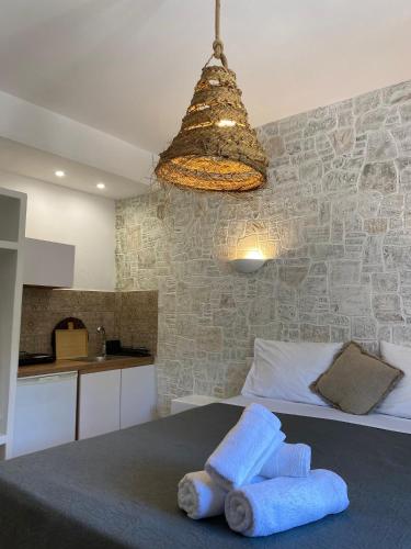 a bedroom with a bed with towels on it at Fotis Studios in Skopelos Town