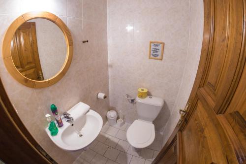 a bathroom with a toilet and a sink and a mirror at Třetí chalupa U Smrčiny in Janske Lazne