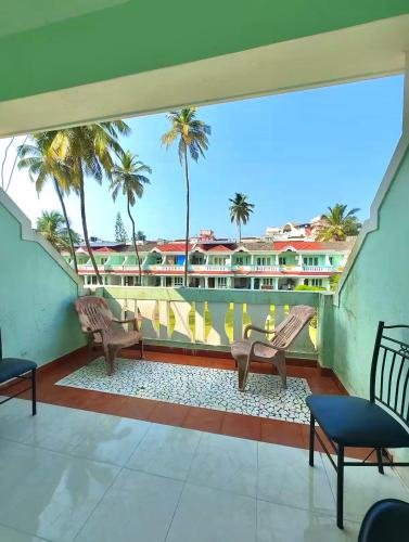 a balcony with two benches and a view of a building at 3 BHK Row Villa in Benaulim