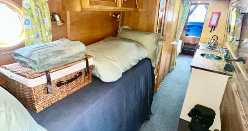 a small bedroom with a bed and a sink at Daisy Mutler Holiday Boat Hire in Bletchley