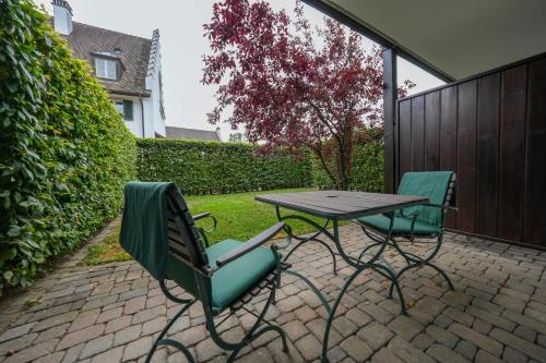 two chairs and a table on a patio at Hofgut Albführen in Dettighofen