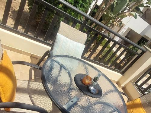 a hat sitting on a table on a balcony at Modern Studio apartment Armonia Court in Paralimni