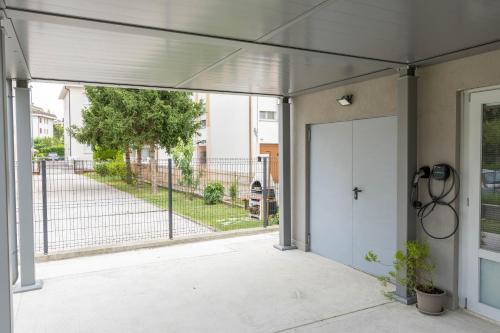an open garage door with a gate and a fence at BBConegliano Borlini in Conegliano
