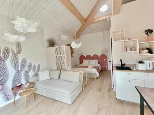 a living room with a couch and a bed at La Rose des Sables suite 5 étoiles in Les Issambres