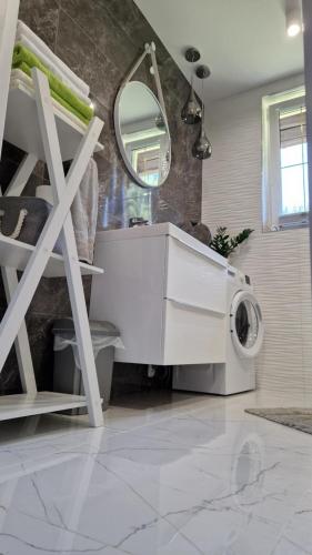 a washing machine in a bathroom with a mirror at Apartament w Krzesznej in Krzeszna