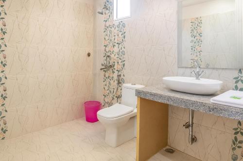 a bathroom with a white toilet and a sink at Emirates Luxury Desert Camps in Jaisalmer