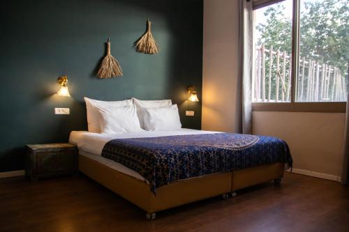a bedroom with a bed and a window with lights at Beit Oren Hotel in Bet Oren
