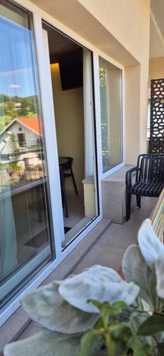 a balcony with a view of a house at Mega Apartmaji in Rogaška Slatina