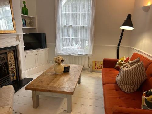 a living room with a couch and a coffee table at Spacious Town house 2 bed 2 mins 2 beach in Deal