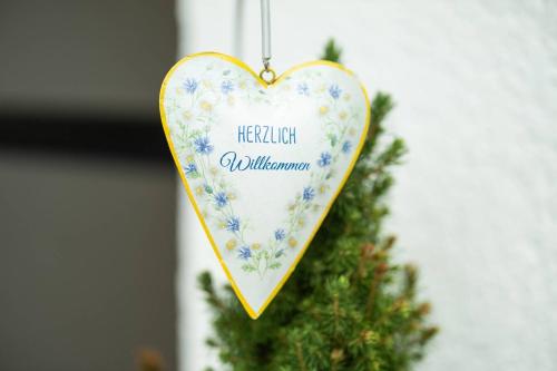 a heart ornament hanging on a christmas tree at Ferienwohnung "Kirchblick" im Ferienhaus Blumenhain in Bad Wünnenberg