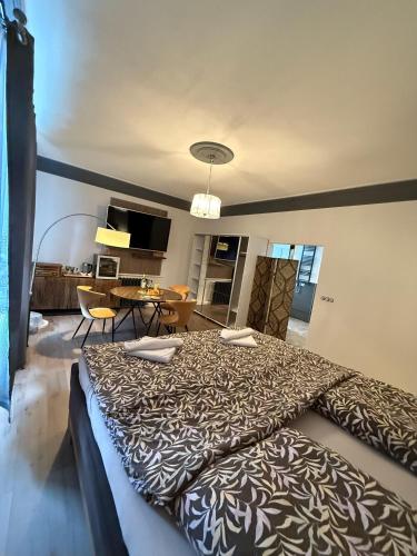 a bedroom with a large bed and a dining room at CG Haensch in Großschönau