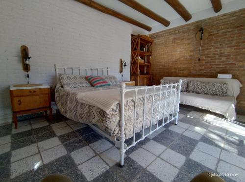 a bedroom with a bed and a dresser in a room at La Vieja Finca in Ciudad Lujan de Cuyo