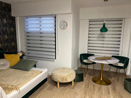 a bedroom with a bed and a table and chairs at La Tropicale in Torrevieja