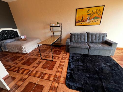 a living room with a couch and a table at Apto - Brasilândia do Sul - PR in Assis Chateaubriand