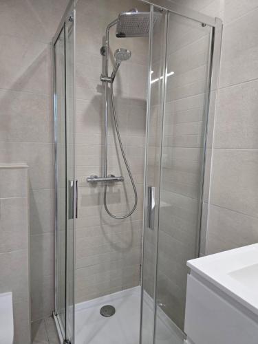 a shower with a glass door in a bathroom at studio balcon, centre ville, parc expo, Arena in Pérols