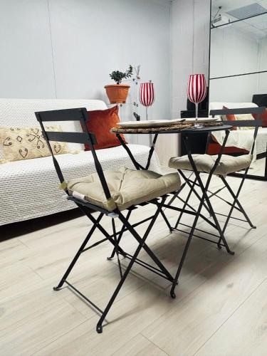 a table and chairs with a bed in a room at Cheap Quiet Double Room in Park Royal with off-site Gym Access to Showers in London