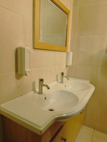 a bathroom with a white sink and a mirror at Cheap Quiet Double Room in Park Royal with off-site Gym Access to Showers in London