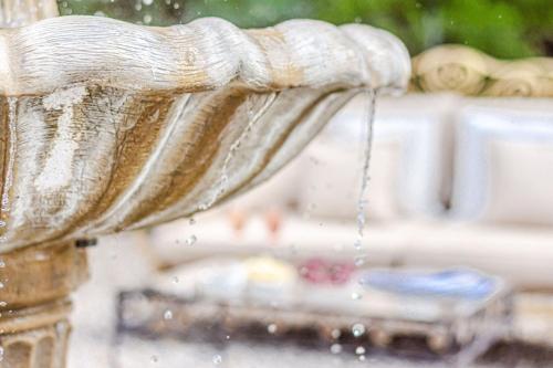 a close up of a water fountain with water coming out at Villa Bolgheri in Montecatini Val di Cecina