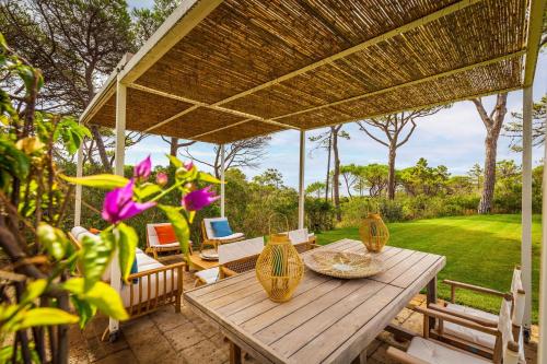 a wooden table with vases on a patio at Villa Dei Pini in Casa Mora