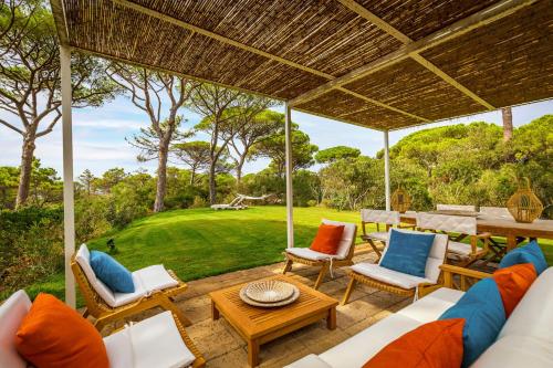 an outdoor patio with chairs and a table at Villa Dei Pini in Casa Mora