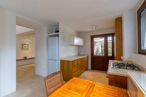a kitchen with a table and a stove top oven at Villa Dei Pini in Casa Mora