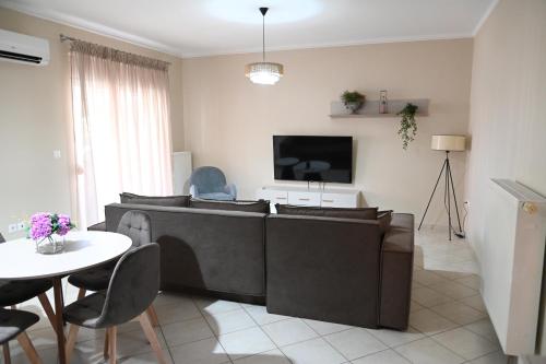 a living room with a couch and a table at Garden Bliss 1 Alexandroupolis in Alexandroupoli